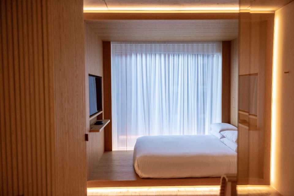 A guest room with a large bed and soft lighting